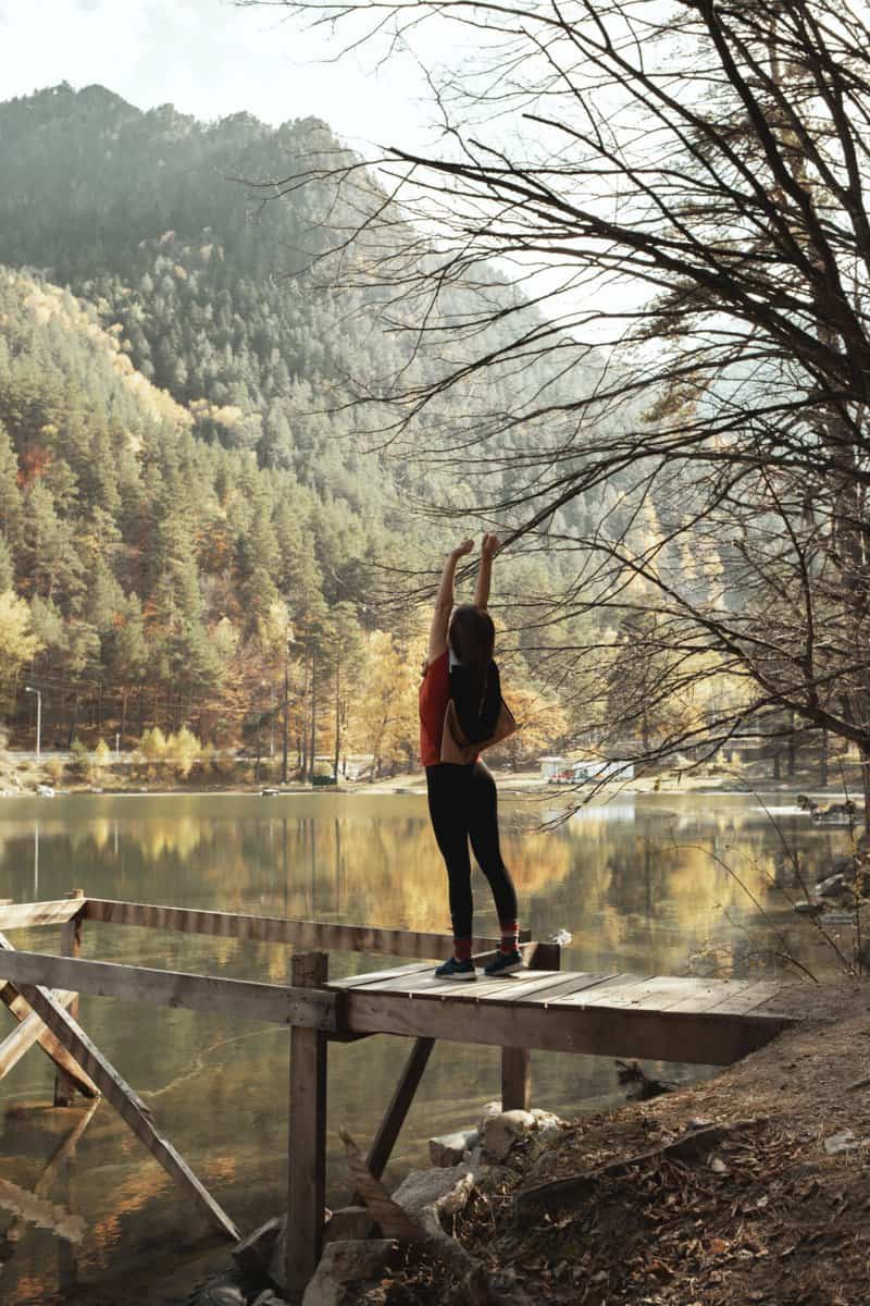 girl stretching in the woods