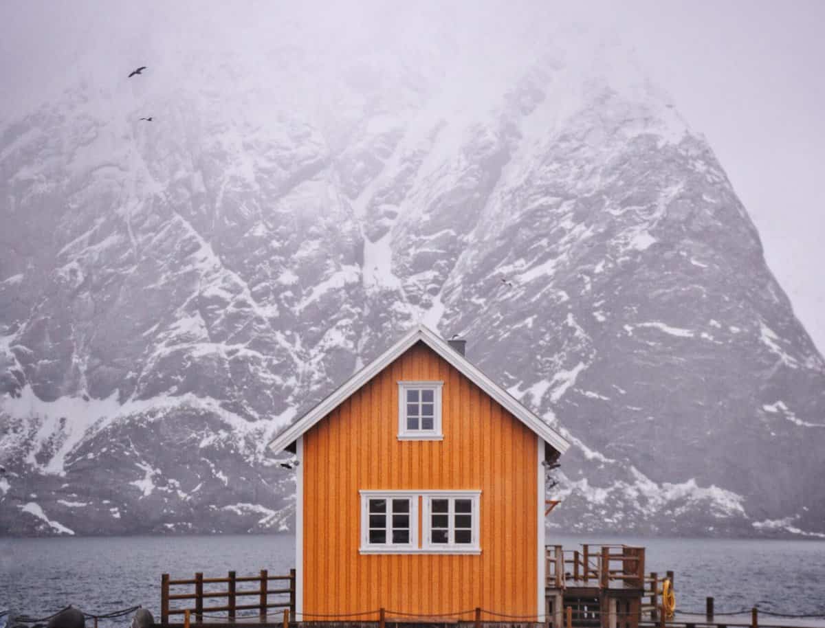 Lofoten yellow house by the mountain