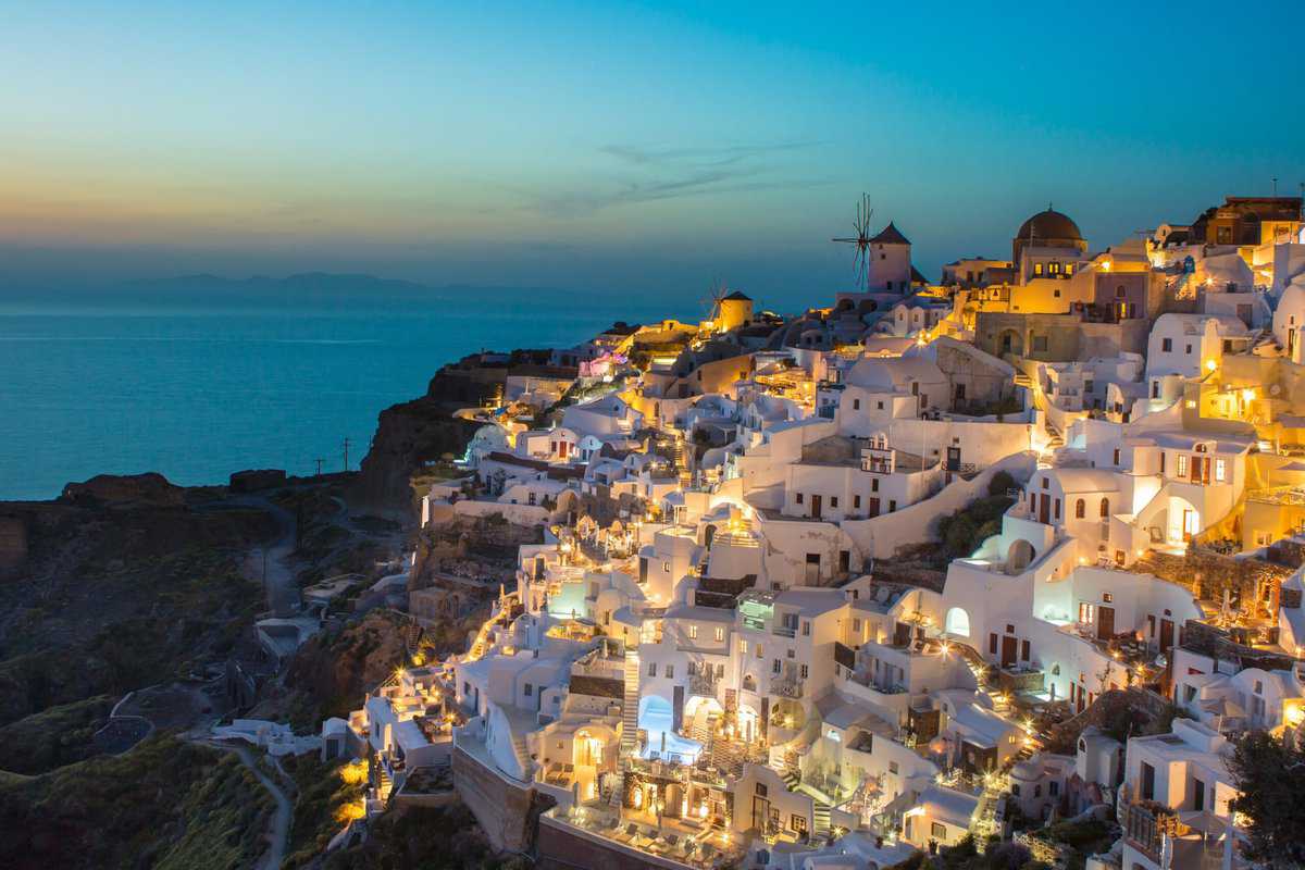 Santorini cliff houses at sunset time