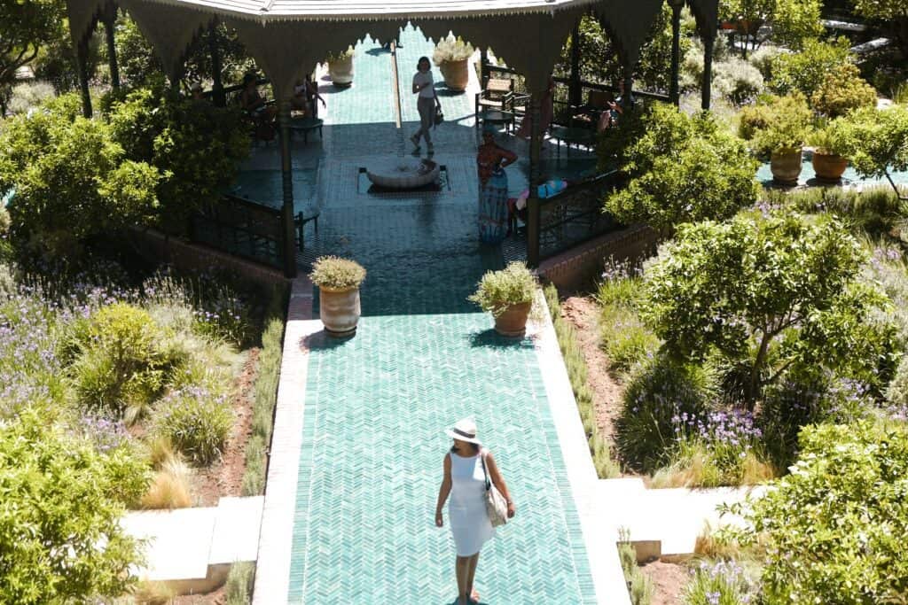 Girl walking in green-tiled garden