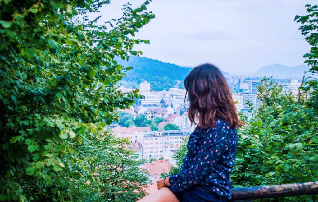 slovenia 5-day itinerary for first time travellers. Girl looking over Ljubljana from the castle
