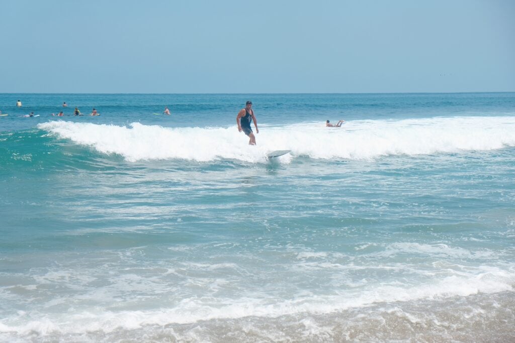 A surfer gracefully rides the waves at Grand Palladium puerto vallarta