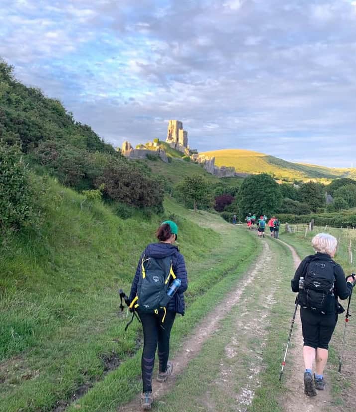 Walkers of jurassic coast mighty hike walking towards Corfe castle