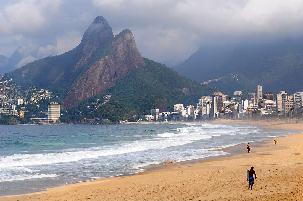 waves and 2 mountain peaks in an empty beach