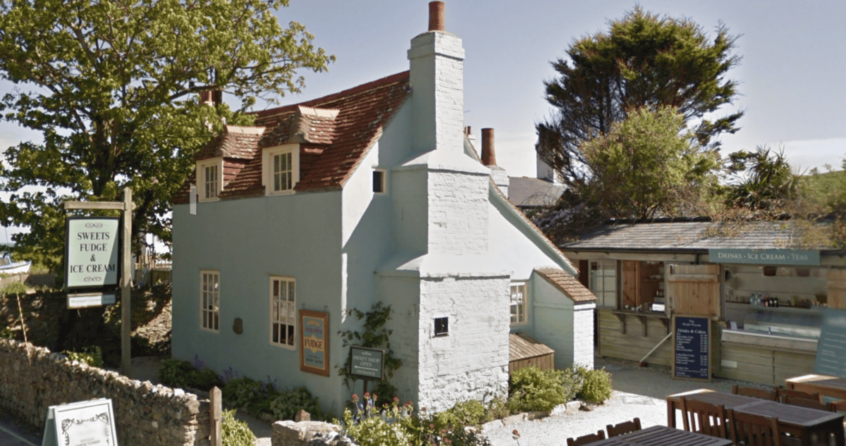 pretty green house called the Doll's house in West Lullworth village