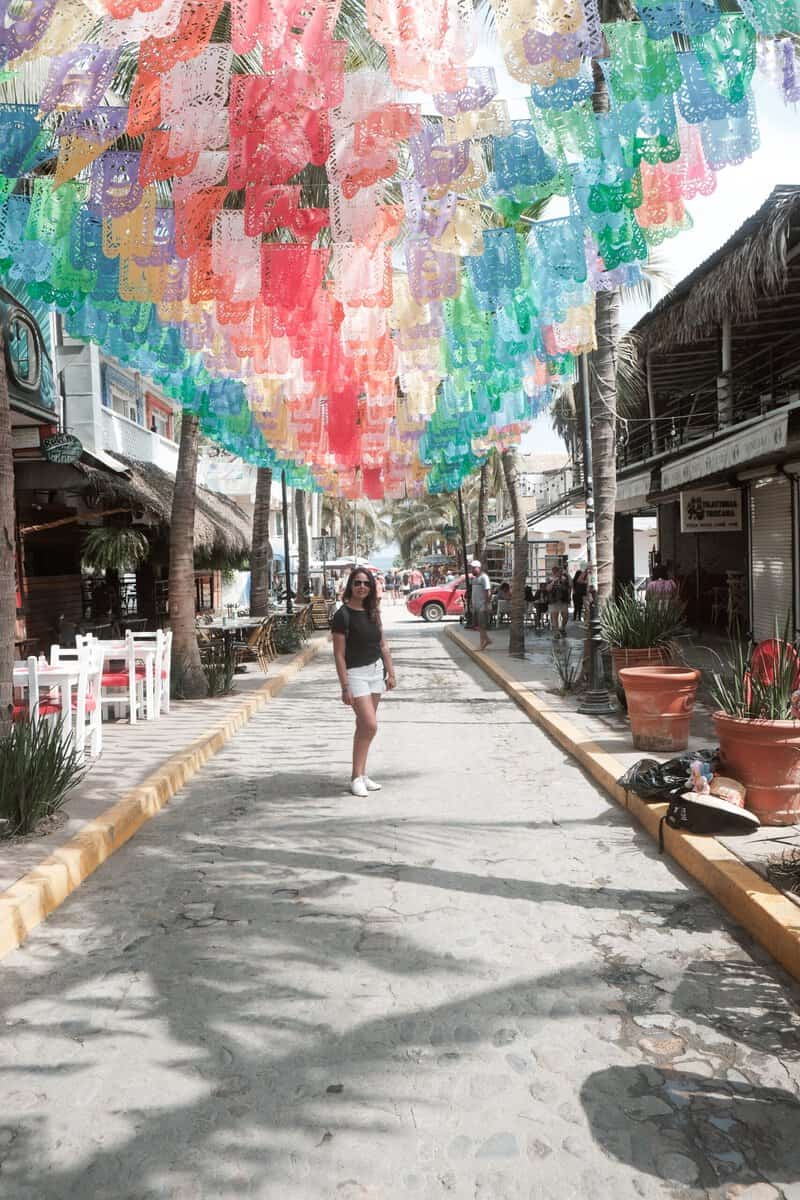 Street art decorations girl walking. Sayulita day trip