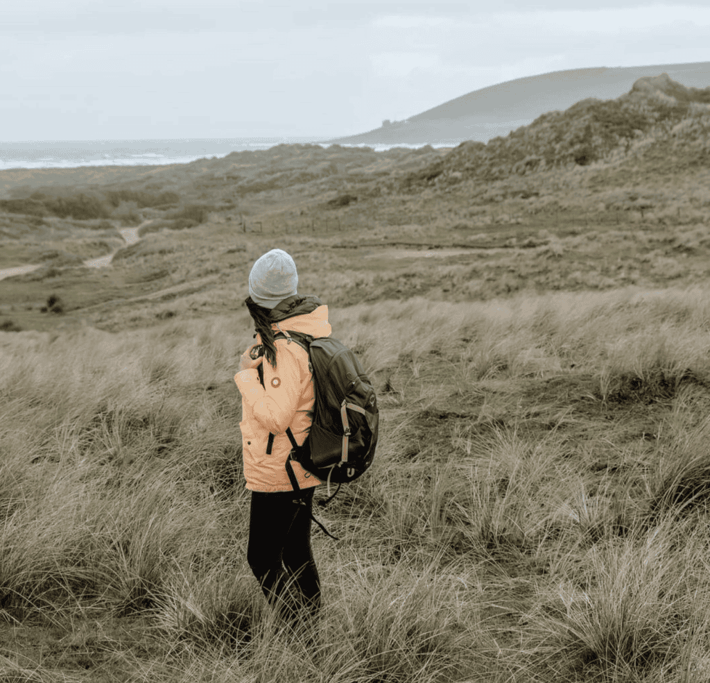 backpacking girl in a field
