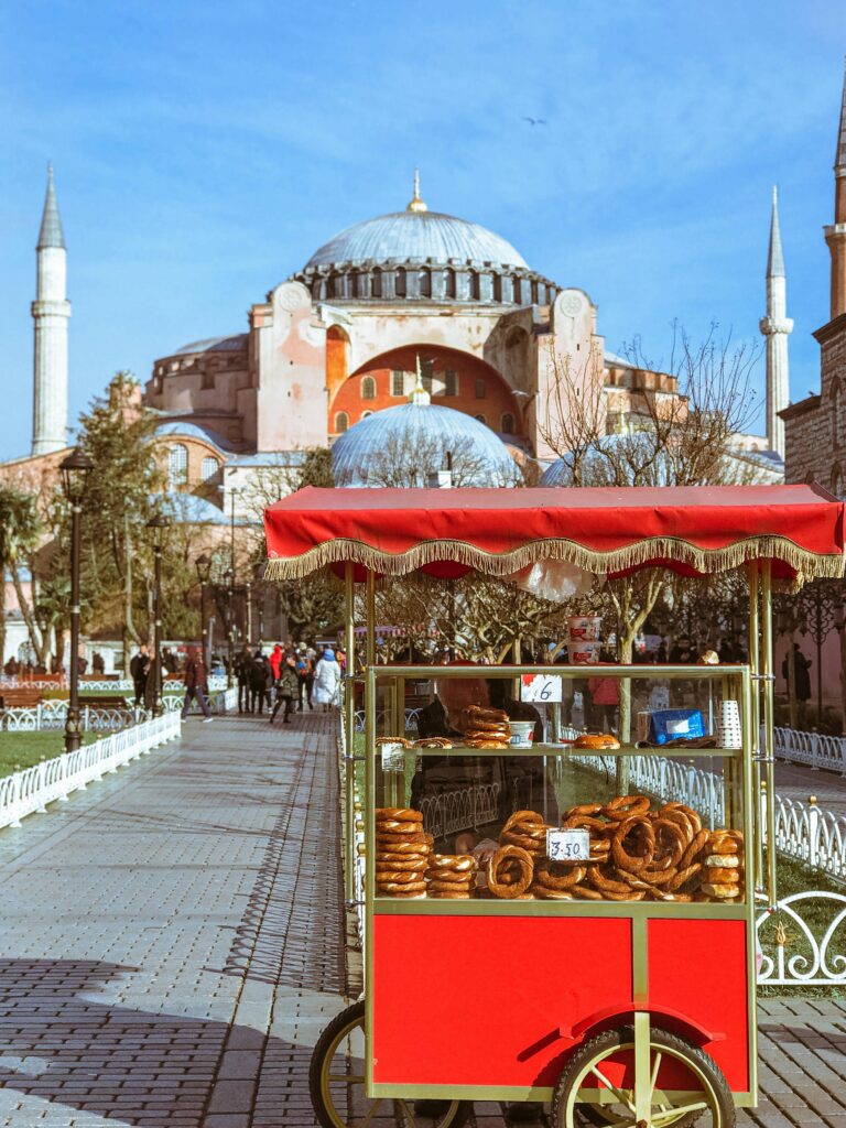 what to eat in Istanbul: red card selling baked goods with haggia sophia in the backfround
